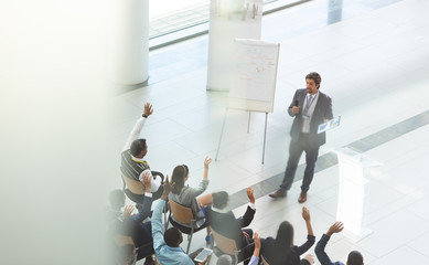 Businessman answering questions at business conference