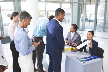 Business people checking in at conference registration table