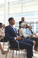 Businessman asking question during seminar