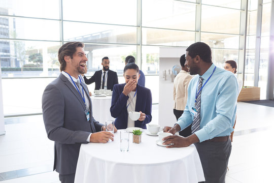 Business people interacting with each other at table during a seminar