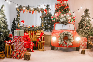 Magic card in red color. Decorated retro car with festive New Year lights, garlands, branches of...