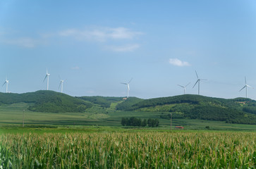 Wind power plants on the hills - green energy.