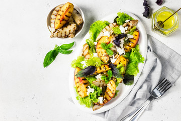 Grilled stone fruit feta cheese salad with basil and peanuts. Top view, copy space.