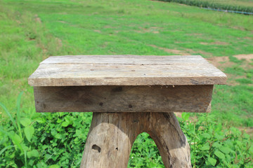 Wooden old table isolated on blurred green nature background.