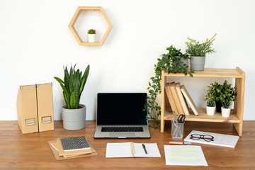 Composition of objects for work of manager, designer or student on desk by wall