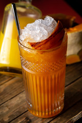 Pumpkin cocktail in a highball glass on a wodden table