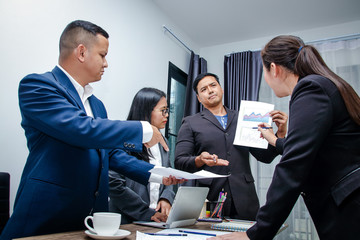 The corporate business team stands a serious meeting to work to achieve the goal.