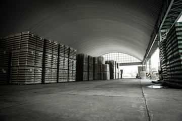 The warehouse has stacked wooden pallets