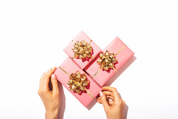 Bunch of pink gift boxes with golden bows