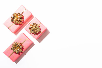 Fototapeta na wymiar Pink gift boxes with shiny golden bows