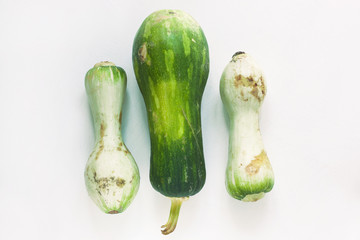 Ugly food concept. Unusual shaped zucchini with mold, scar-like structure, scratches. Top view.