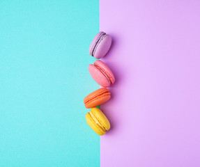 macarons with cream on a purple-green background