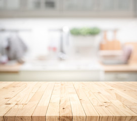 Wood table top on blur kitchen counter (room)background.For montage product display or design key...