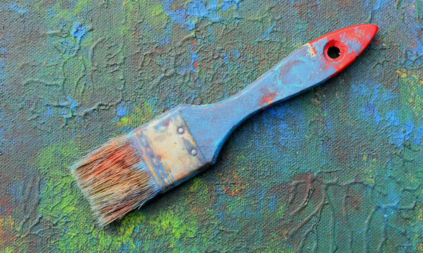 Brush on a paint palette. Acrylic paint.