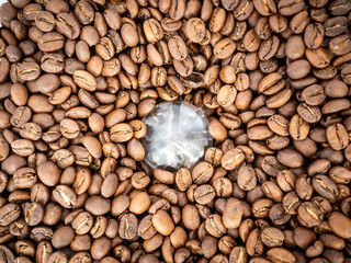 Coffee beans texture. Full frame background texture of coffee beans, top down, in a commercial grinder.