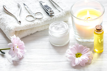 Obraz na płótnie Canvas spa nail care with aroma candle on wooden background