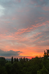 Landscape with dramatic light - beautiful golden sunset with saturated sky and clouds.