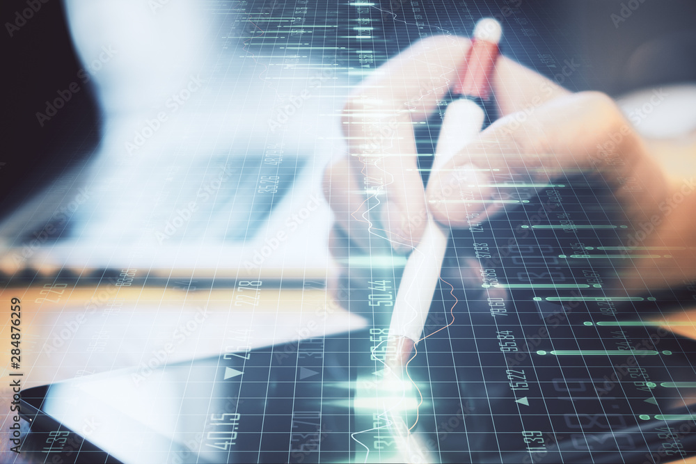Poster hands using device with forex graph