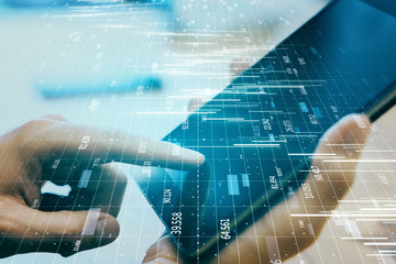 Hands using tablet with big data