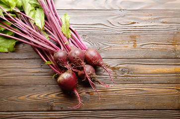 Top view at Fresh organic beetroots on kitchen wooden rustic table
