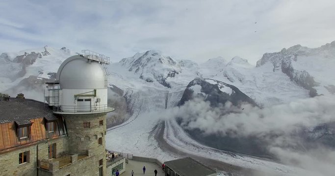 A drone flies by astronomy Telescope in Gornergrat Zermatt in Alps Mountains, Switzerland