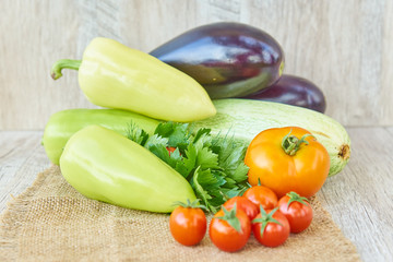 close up of freshly pickled harvest of vegetbles - bell pepper, drill and tomatoes on wooden table. Rustic style. Organic healthy food concept with copy space