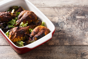 Roasted tandoori chicken with basmati rice on wooden table. Copyspace