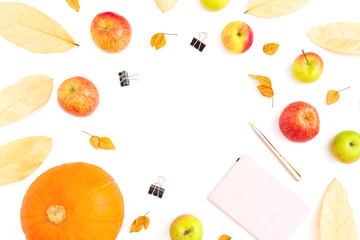 Autumn composition of fall leaves, apple and pumpkin with notebook, pen and clips on white background. Thanksgiving day. Flat lay, top view