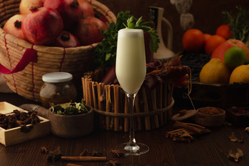cocktail dekorate parsley on a wooden background. Background decorated with fruits and herbs.