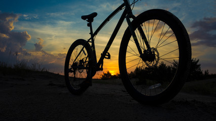 Fototapeta na wymiar bicycle on beach at sunset