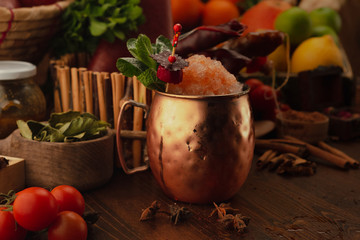 moscow mule cocktail on a wooden background. Background decorated with fruits and herbs.
