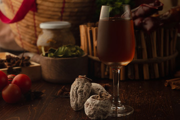 cocktail in a glass on a wooden background. Background decorated with fruits and herbs.