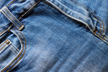 Fragment of blue denim with a pocket.