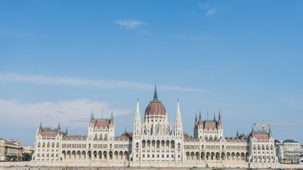 Fototapeta na wymiar Parliament In Budapest, Hungary from the opposite side of the riverside in the buda part of the city. Famous landmark in the world in the capital of the country