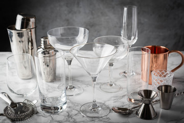 cocktail glasses and utensils on marble table