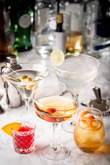 collection of classic cocktails, negroni, old fashioned, manhattan, margarita, martini