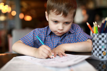 Child drawing with pencil