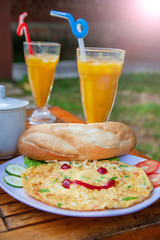 Breakfast with scrambled eggs, cheerful breakfast, omelette with a smile from ketchup, bread, vegetables  salad