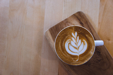 coffee hot drink cappucino latte art on wood vintage table , coffee time on wood background cafe