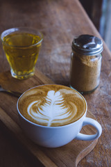 coffee hot drink cappucino latte art on wood vintage table , coffee time on wood background cafe