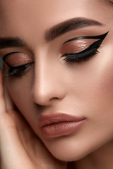 luxury woman make-up with golden shadow and black eyeliner