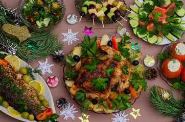 Christmas holiday table with chicken, fish, vegetables, canapes