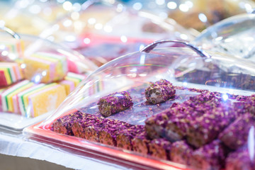 Traditional Turkish Delight Rahat Lokum and Other Oriental Sweets in Market. Traditional Purple...