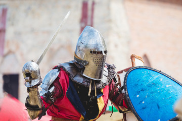 Knight with sword in raised hand during duel_