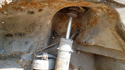 A stand of an old and rusty car closeup. Auto part close-up. A wrecked car at a car service is not...
