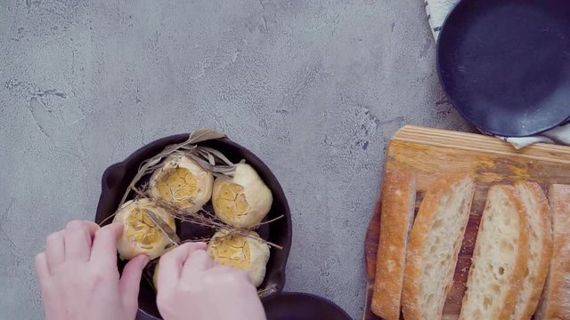 Time lapse. Flat lay. Spreading freshly made garlic spread on slice of ciabatta bread.