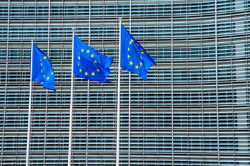 European Union blue flags waving in the wind near EU commission building