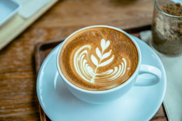 coffee aroma latte cup in the wood table cafe style