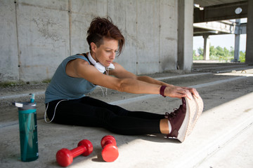 Girl with modern haircut stretching after workout