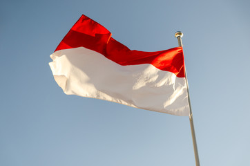 Fototapeta na wymiar Flag of Indonesia waving in the wind
